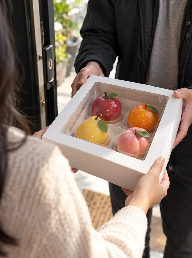 A box of fruit-shaped desserts ready to hand over to a customer
